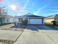 Single-story house with attached garage and landscaped front yard at 2022 Peaceful Palm St, Ruskin, FL 33570