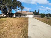 Cute one-story house with a long driveway and a spacious yard at 4000 Barbary Ln, North Port, FL 34287