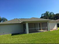 House with screened patio and grassy backyard at 4666 Laramie Cir, North Port, FL 34286