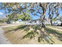 Newly renovated house with a white brick exterior and a spacious yard at 27111 Wakefield Dr, Brooksville, FL 34602