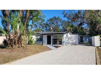 Updated home exterior boasts a modern design and landscaped yard at 231 W Cornelius Cir, Sarasota, FL 34232