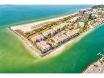 Aerial view of waterfront condos with beach access at 7532 Bayshore Dr # 203, Treasure Island, FL 33706