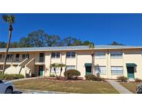 Inviting two-story condo with well-maintained landscaping and palm trees at 4885 Rilma Ave # 130, Sarasota, FL 34234