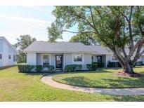 Cute ranch home with a landscaped lawn and a large shade tree at 7710 Danube Dr # A, Hudson, FL 34667
