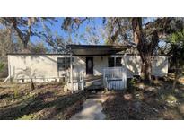 Mobile home with covered porch and small yard at 10920-10928 Malati St, New Port Richey, FL 34654
