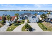 Beautiful waterfront home featuring an attached two car garage, with lovely landscaping and water views at 6354 Cocoa Ln, Apollo Beach, FL 33572