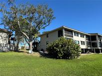 A charming condo with a cozy, screened porch overlooking a lush lawn and mature tree at 1813 Mariner Dr # 152, Tarpon Springs, FL 34689