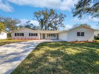 Charming single-story home featuring a long driveway and a well-maintained front yard at 7013 Doreen St, Tampa, FL 33617