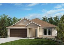 Charming single-story home boasts a well-manicured lawn, brown roof, and an attached two-car garage at 7953 Lennox Loop, Land O Lakes, FL 34638