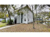Charming two-story condo with exterior siding, black railings, and an inviting waterfront view at 7120 Waterside Dr # 106, Tampa, FL 33617