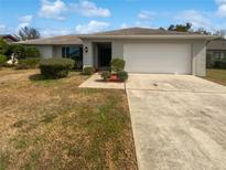 Traditional one-story home with an attached two-car garage and a well-manicured lawn at 3402 Rankin Dr, New Port Richey, FL 34655