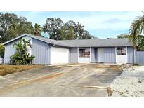 Single-story home showcasing painted siding, concrete driveway, and a well-manicured front yard at 5109 19Th W St, Bradenton, FL 34207