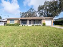 Well-maintained single-Gathering home featuring a long driveway and lush lawn at 908 Greenwell Dr, Brandon, FL 33511