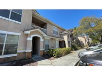 Inviting townhouse with neutral stucco, an open entryway, manicured bushes and well maintained grounds at 17952 Villa Creek Dr # 17952, Tampa, FL 33647