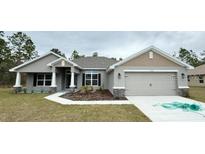 Attractive one-story home with a two-car garage and well-maintained lawn at 13009 Parade Ave, Weeki Wachee, FL 34614