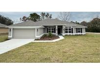 Newly constructed one-story home with attached garage and landscaping at 6101 Roble Ave, Spring Hill, FL 34608