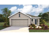 One-story home with neutral exterior, two-car garage, and landscaping at 30945 Wild Juniper Ct, Brooksville, FL 34602