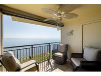 Relaxing balcony seating with beautiful water views, overhead fan, and tiled flooring at 6372 Palma Del Mar S Blvd # Apt 307, St Petersburg, FL 33715