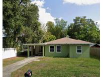 Green house with carport and spacious yard at 1073 Putnam Dr, Sarasota, FL 34234