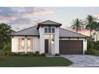 Single-story home with a tile roof, two-car garage, and landscaped lawn at 233 Vistera Blvd, North Venice, FL 34275