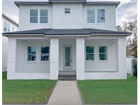 Two-story home with white exterior and a landscaped lawn at 820 46Th N Ave, St Petersburg, FL 33703