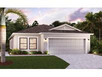 Single-story home with gray garage door and landscaping at 16893 Fiesta Dr, Port Charlotte, FL 33953