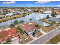 Aerial view of a beautiful home community with water features and lush landscaping at 1718 S Pebble Beach Blvd, Sun City Center, FL 33573