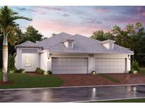 Two-car garage, light-colored exterior, and a nicely landscaped yard at 18063 Cherished Loop, Bradenton, FL 34211