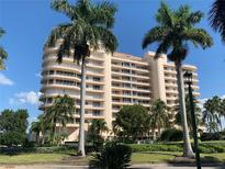 Luxury high-rise building with palm trees and lush landscaping at 3060 Grand Bay Blvd # 174, Longboat Key, FL 34228