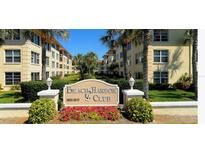 Beach Harbor Club condo building with lush landscaping and a welcoming entrance at 3806 Gulf Of Mexico Dr # C310, Longboat Key, FL 34228