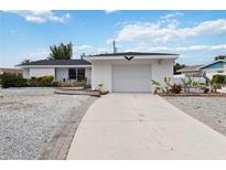 White single-story house with a garage and landscaped yard at 6628 Keystone Dr, Sarasota, FL 34231