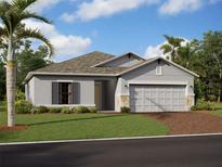 One-story house with gray siding, two-car garage, and landscaped lawn at 9832 Last Light Gln, Parrish, FL 34219