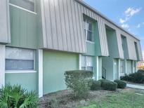 Light green building exterior with well-manicured landscaping at 7450 35Th N St # 1604, Pinellas Park, FL 33781