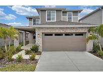 Two-story home with stone accents and two-car garage at 5943 Jensen View Ave, Apollo Beach, FL 33572