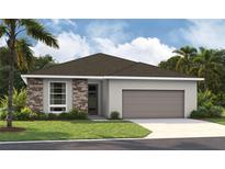 One-story home with stone accents and a two-car garage at 9071 Players Dr, Weeki Wachee, FL 34613