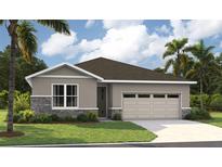 One-story home with gray siding, stone accents, and a two-car garage at 9109 Players Dr, Weeki Wachee, FL 34613
