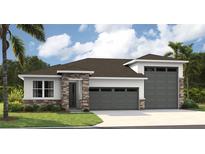 Two-story home with stone accents and a two-car garage at 9157 Players Dr, Weeki Wachee, FL 34613