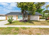 Ranch-style home with stone accents and a two-car garage at 7403 Foxbloom Dr, Port Richey, FL 34668