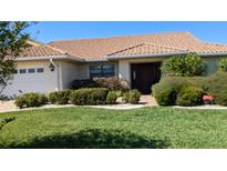 Single-story home with tile roof, landscaped yard, and attached garage at 721 Plumbrook Rd, Sun City Center, FL 33573