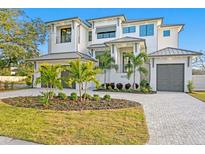 Stunning waterfront home with two-car garage and lush landscaping at 5032 W Longfellow Ave, Tampa, FL 33629