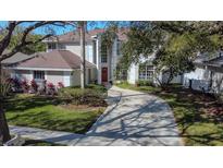 Two-story house with a red door and a large driveway at 9330 Hampshire Park Dr, Tampa, FL 33647