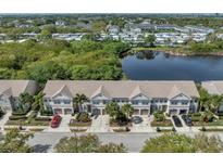 Aerial view of townhouses with lake access at 528 Black Lion Ne Dr, St Petersburg, FL 33716