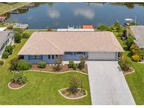 Single-story home with waterfront access and landscaped yard at 1707 Tahoe Dr, Sun City Center, FL 33573