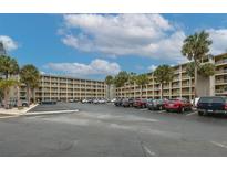 Two-story condo building with ample parking and tropical landscaping at 3753 Lake Bayshore Dr # H305, Bradenton, FL 34205