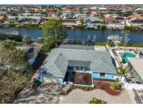 Aerial view of waterfront home with pool and canal access at 909 Birdie Way, Apollo Beach, FL 33572