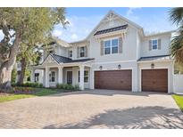 Beautiful two-story home featuring a brick driveway and a three car garage at 4010 W Watrous Ave, Tampa, FL 33629