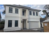 Modern two-story home featuring a symmetrical facade and integrated two-car garage at 3707 W San Juan St, Tampa, FL 33629