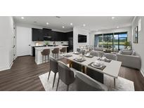 Open concept kitchen and dining area with dark cabinetry and modern appliances at 3778 Maxwell Park Dr, Sun City Center, FL 33573