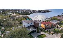 Beautiful aerial view of a modern two-story home on a waterfront property with bay access at 5006 W San Miguel St, Tampa, FL 33629