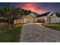 Craftsman style home with paver driveway and landscaped yard at 5034 Elm Leaf Dr, Brooksville, FL 34601